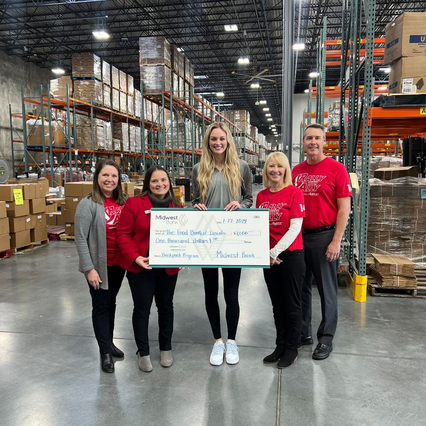 Ally Batenhorst and Midwest Bank team up to donate to Lincoln Food Bank.