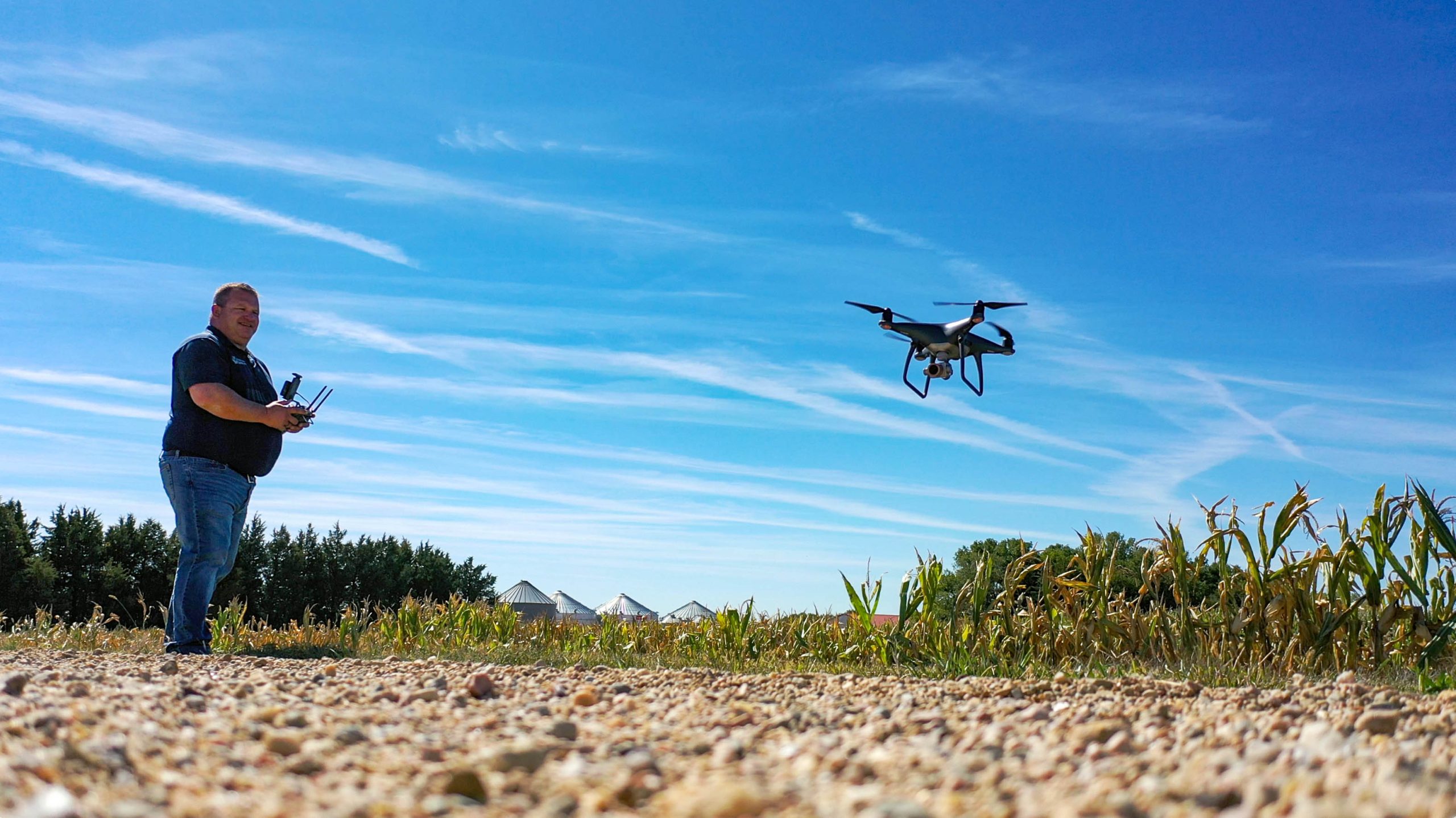 Midwest Bank Agency agent, Josh with his drone in a corn field