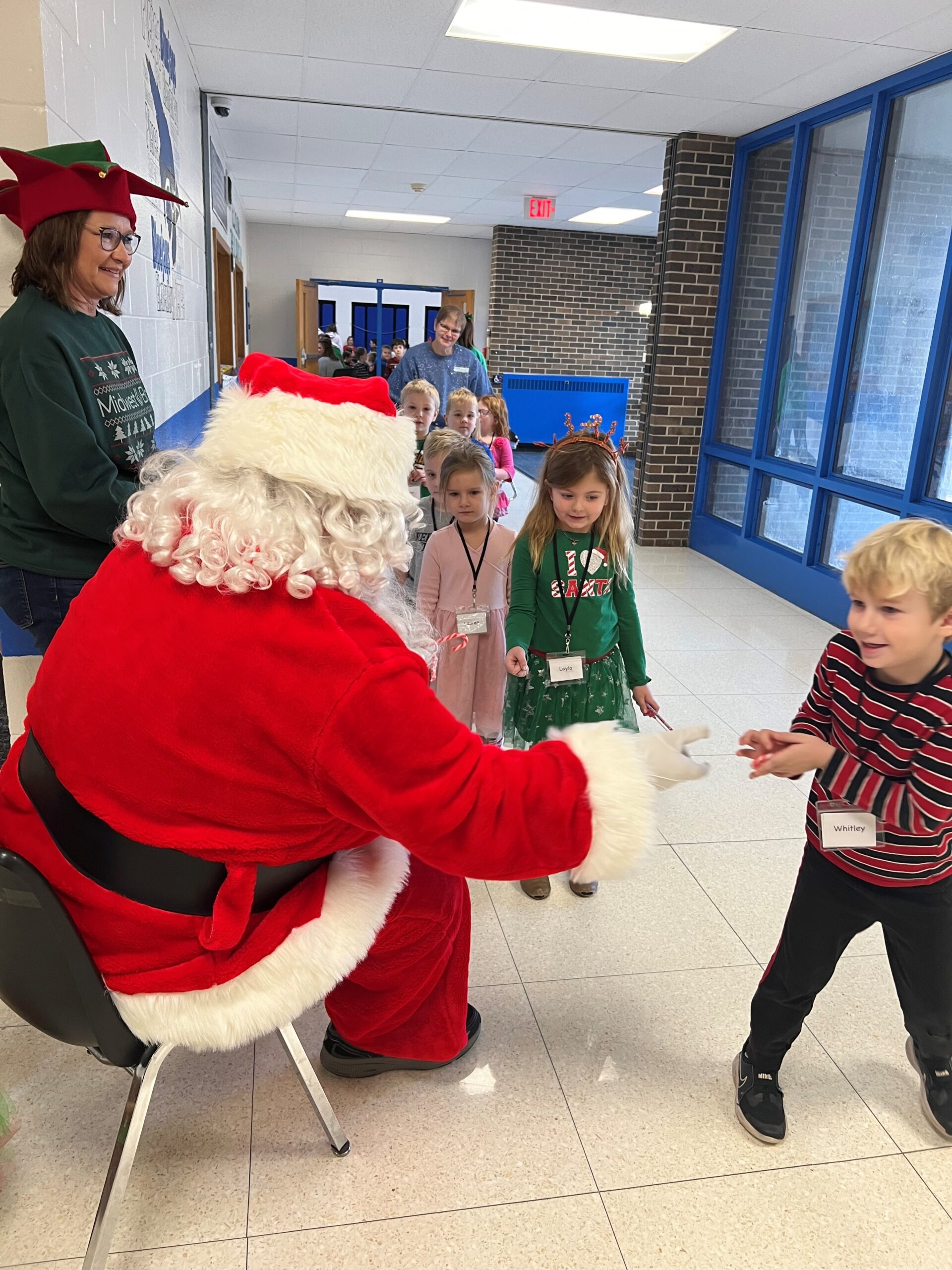 Midwest Bank staff visits Pierce Elementary School and Zion Lutheran School with Santa