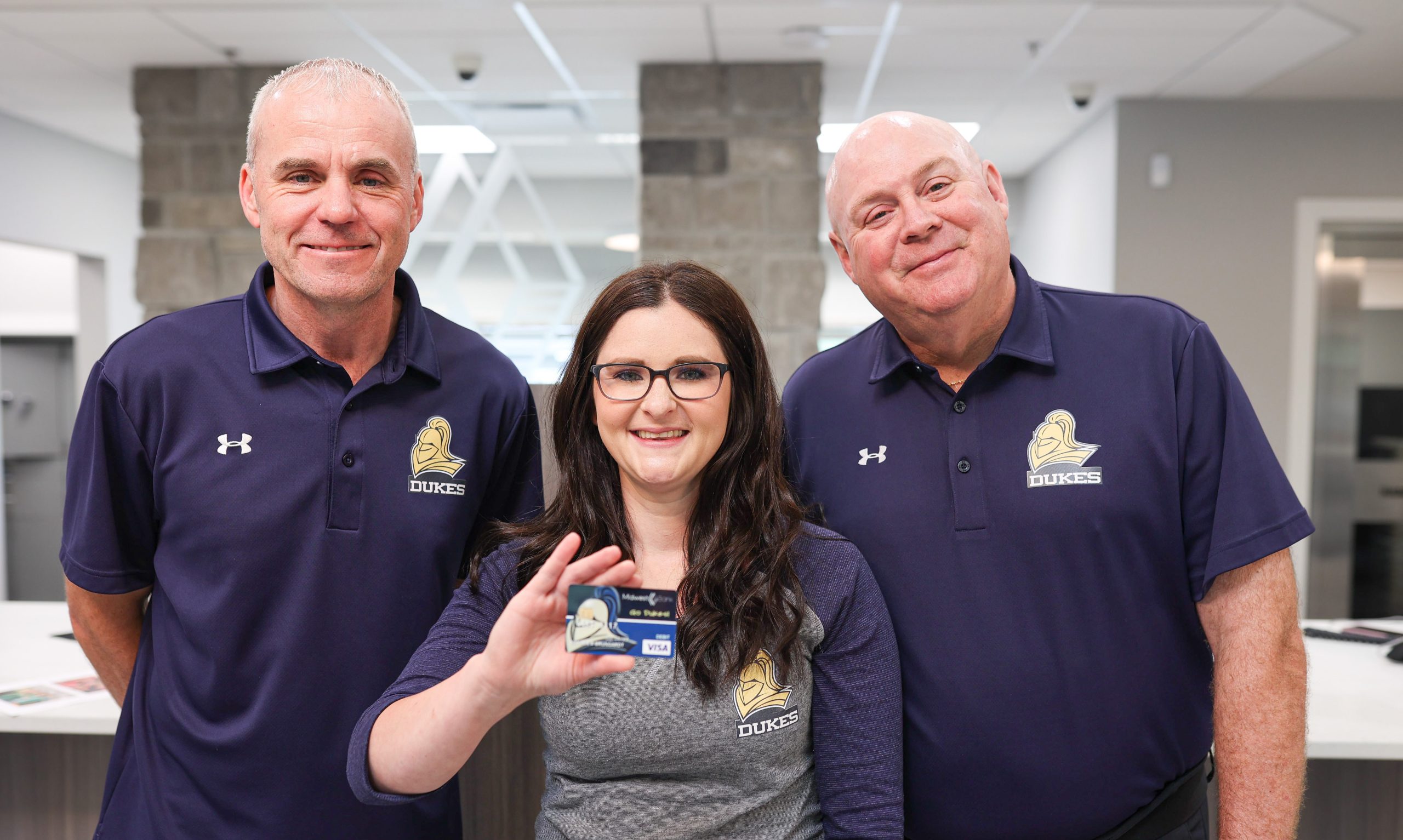 York staff Chad, Kailie and Barry holding the York mascot debit card