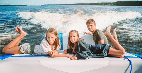 Family having fun on a motorboat in the summer.