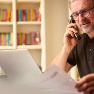 Older man doing business on his home computer