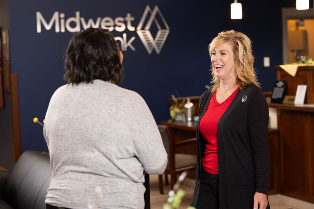 Midwest Bank employee laughing with a client.