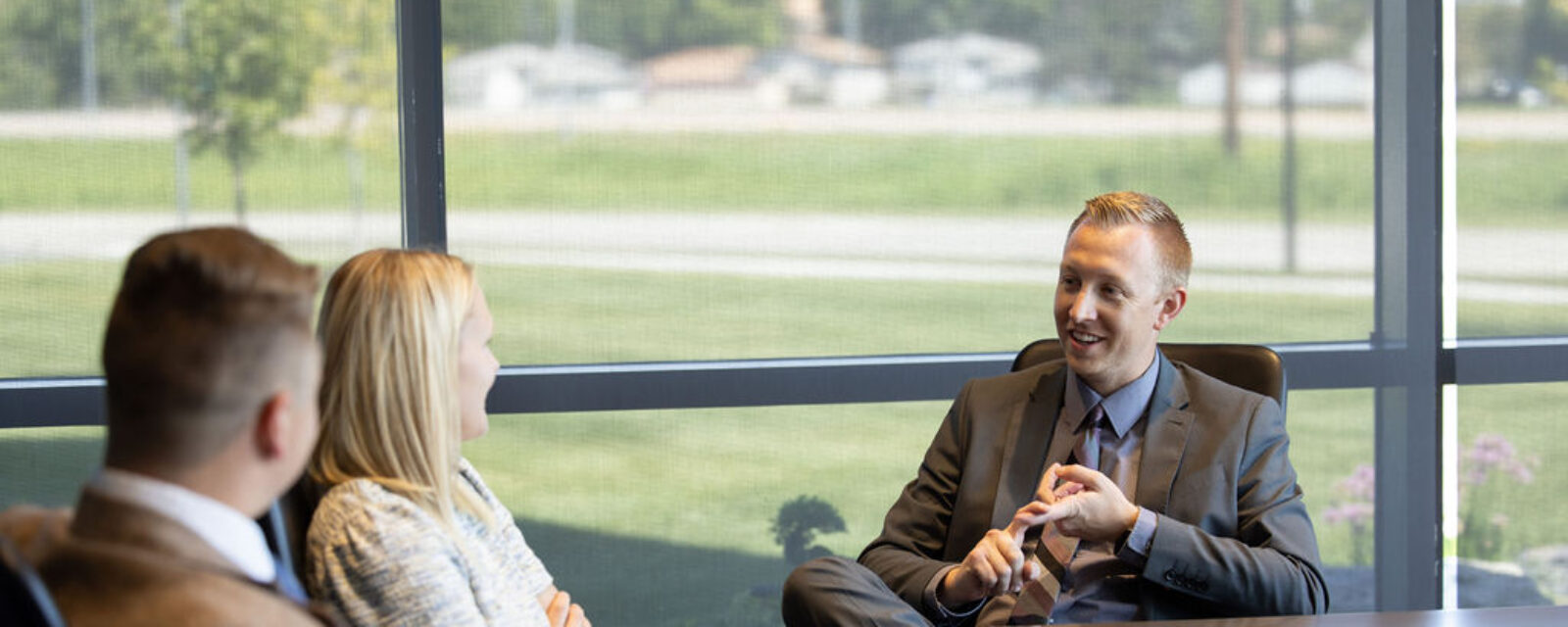 Steven, Ashton, and Lane talking in the conference room