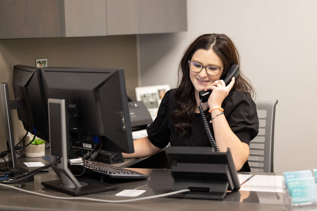 Kailie McCarville, a Loan Admin out of York, answering the phone at her desk