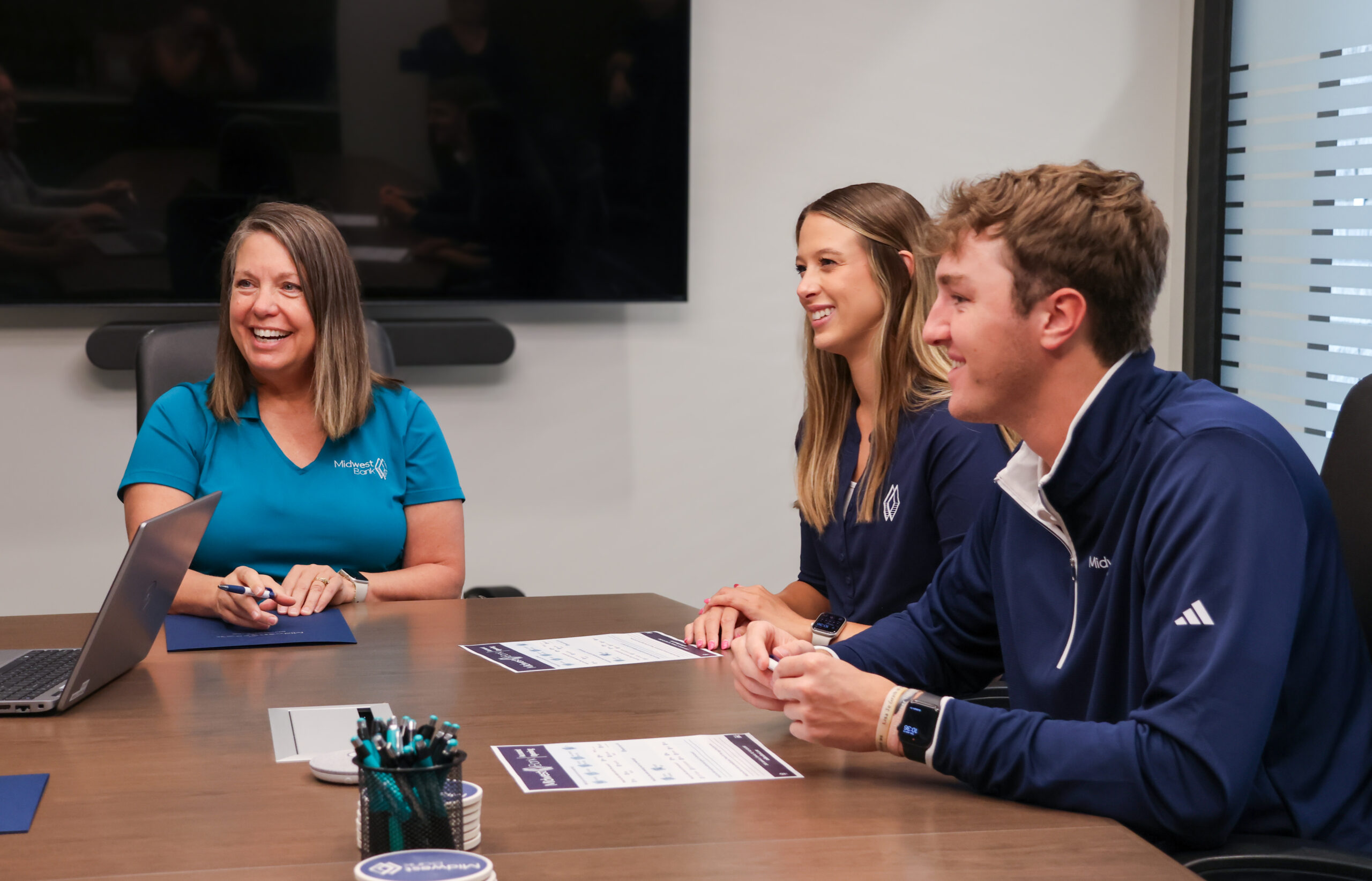 Lincoln staff sitting around a board table smiling