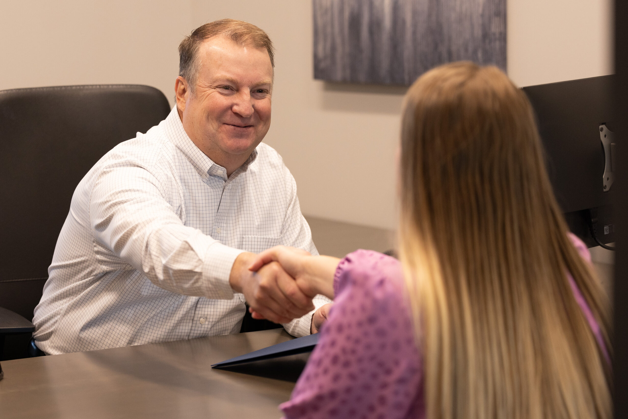 Jeffry Phillips shaking hands with client.