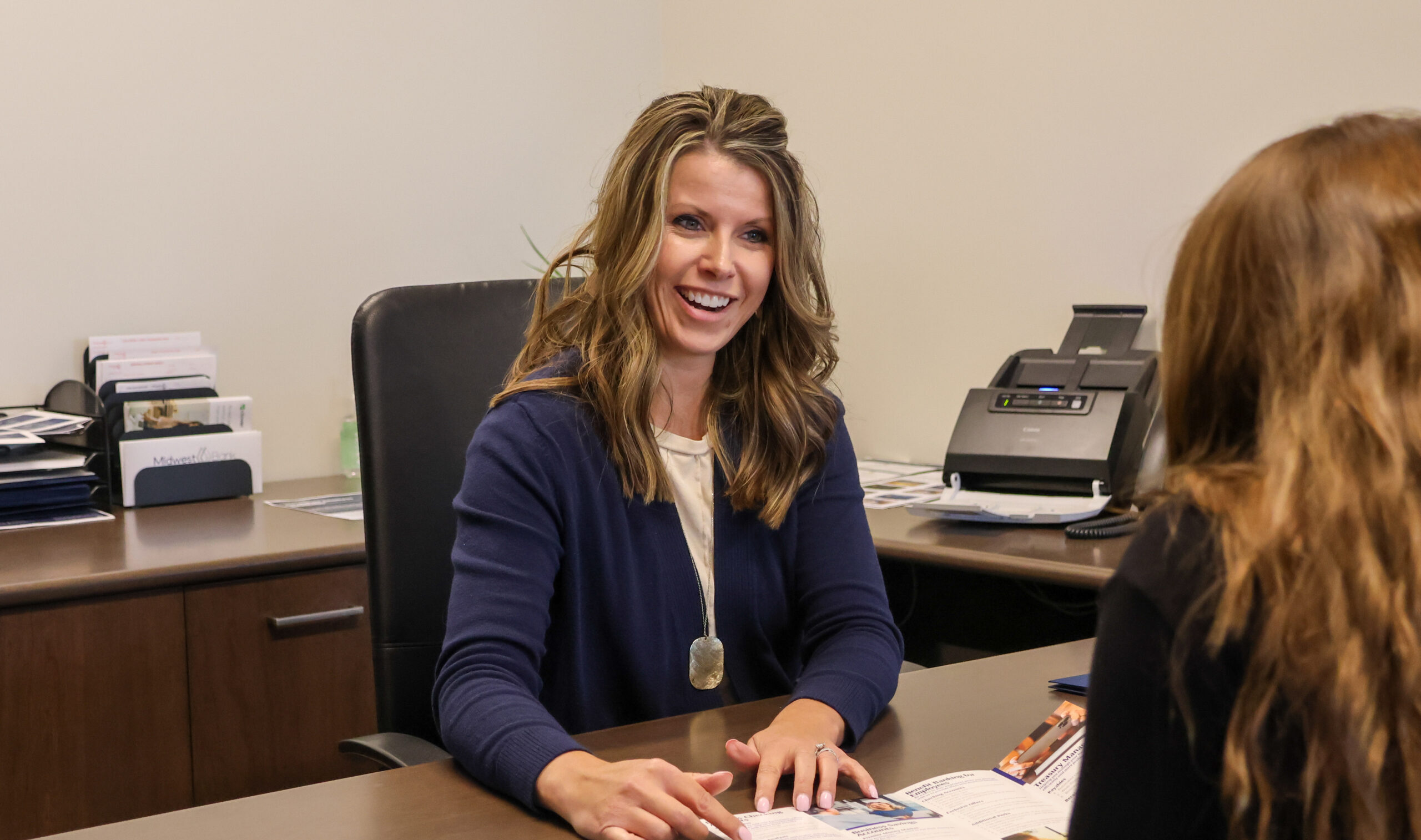 Kim Foreman at the Lincoln branch helping a customer at her desk