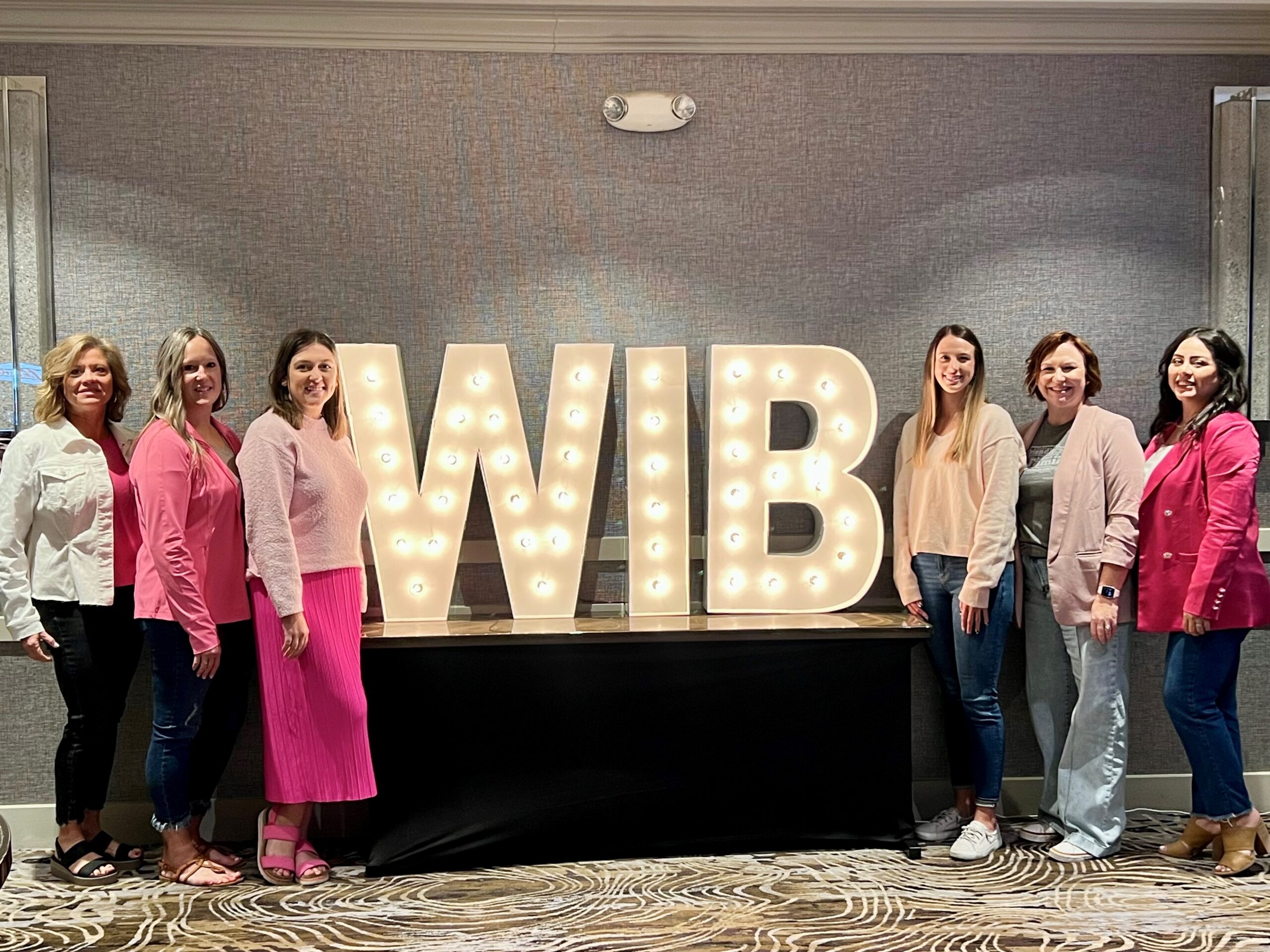 Midwest Bank Staff wearing pink to share awareness for breast cancer at the Women in Banking Conference 2024