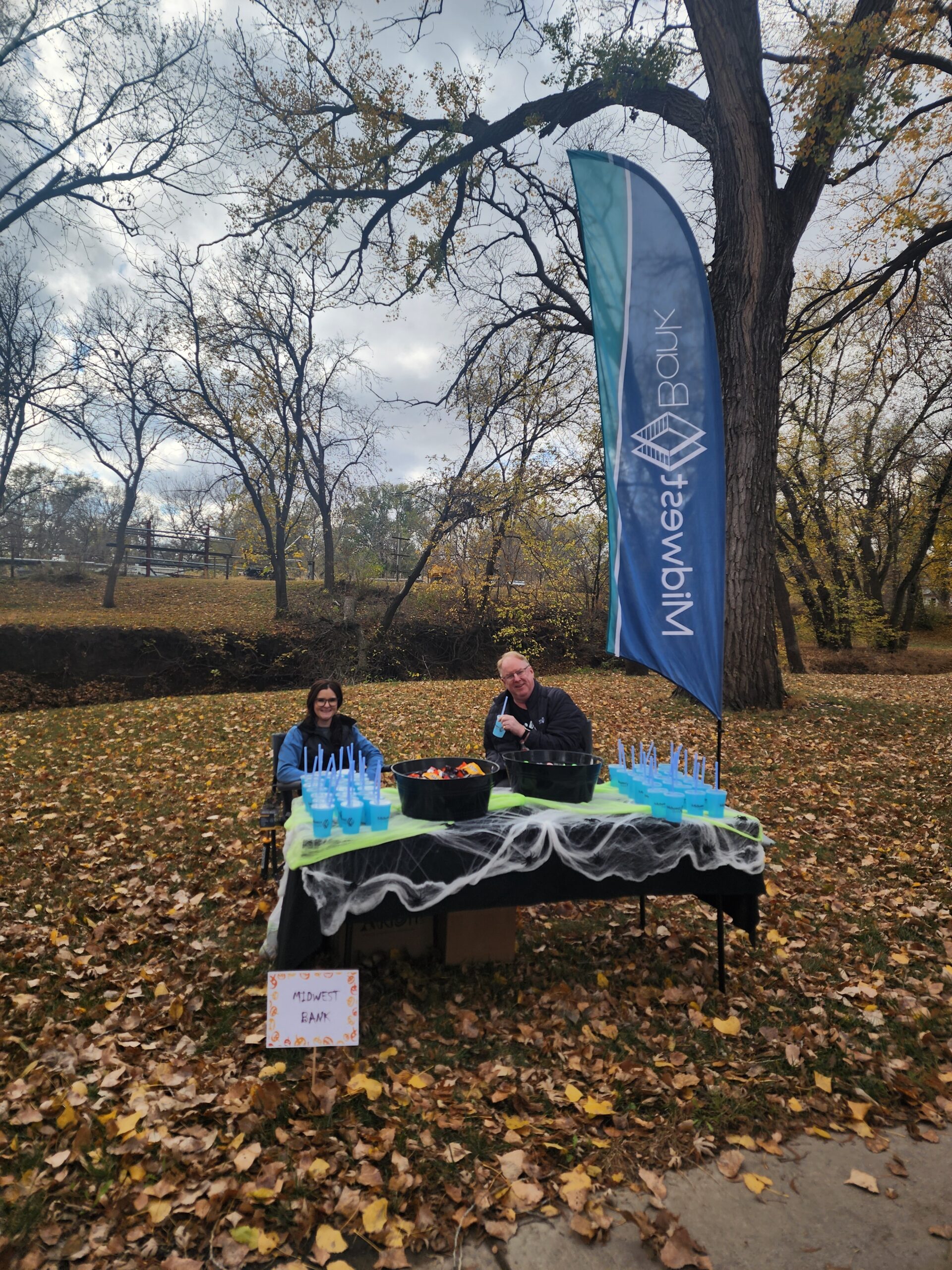 Kailie McCarville and Randy Waskowiak at a booth for Treats on the Trail