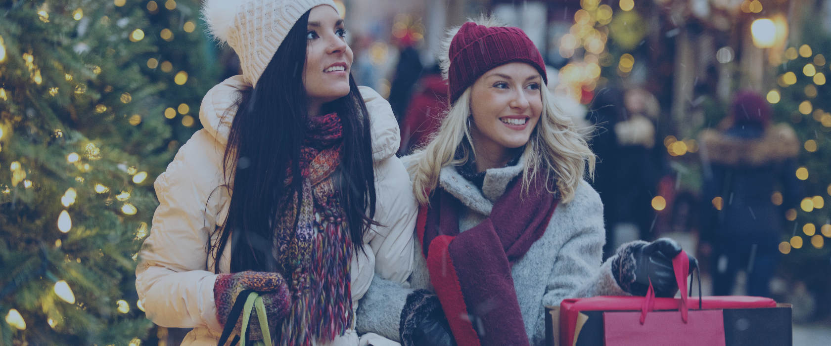 Two women shopping at Christmas time holding shopping bags