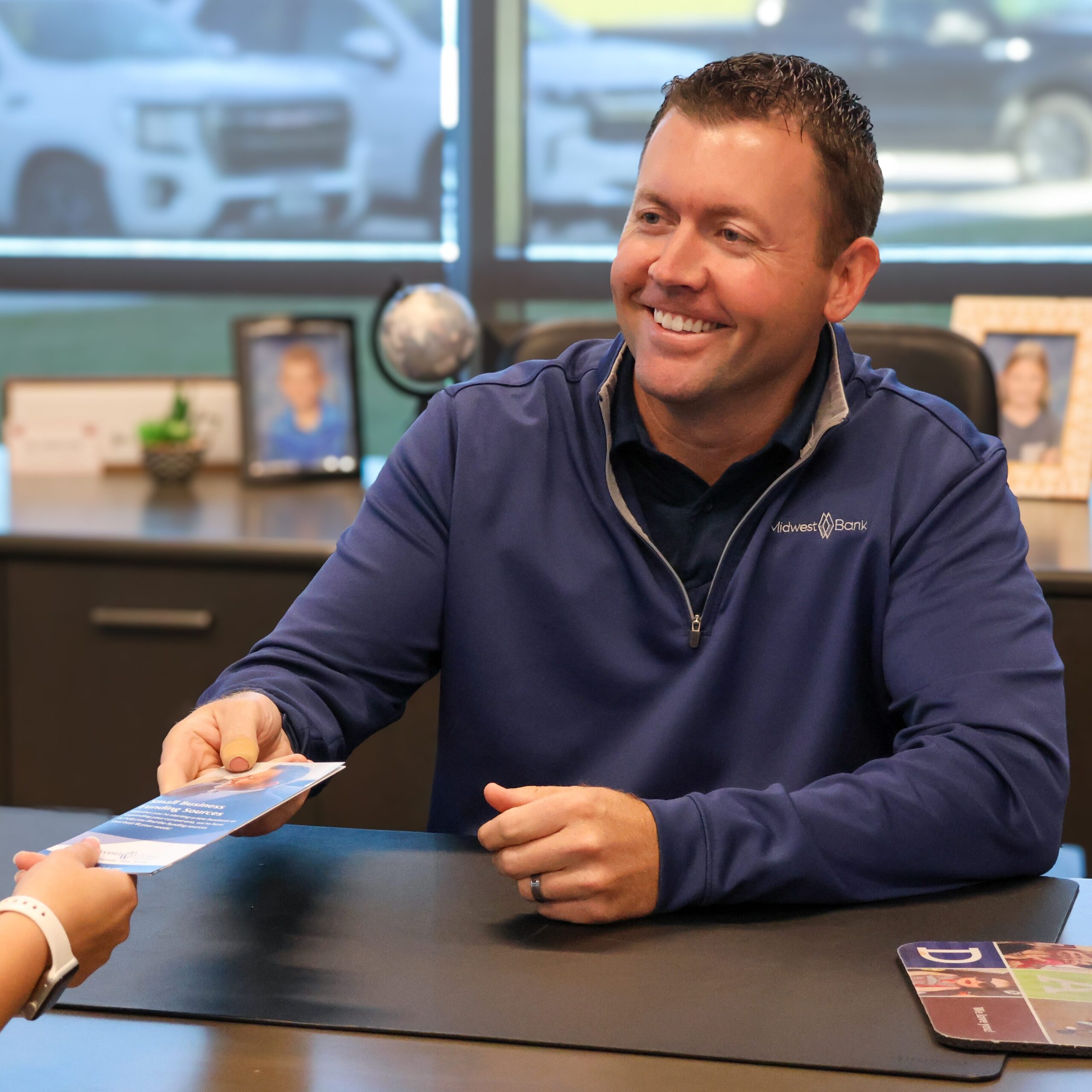 Jason Love, market president in Norfolk helping a client at his desk with their new business idea. 