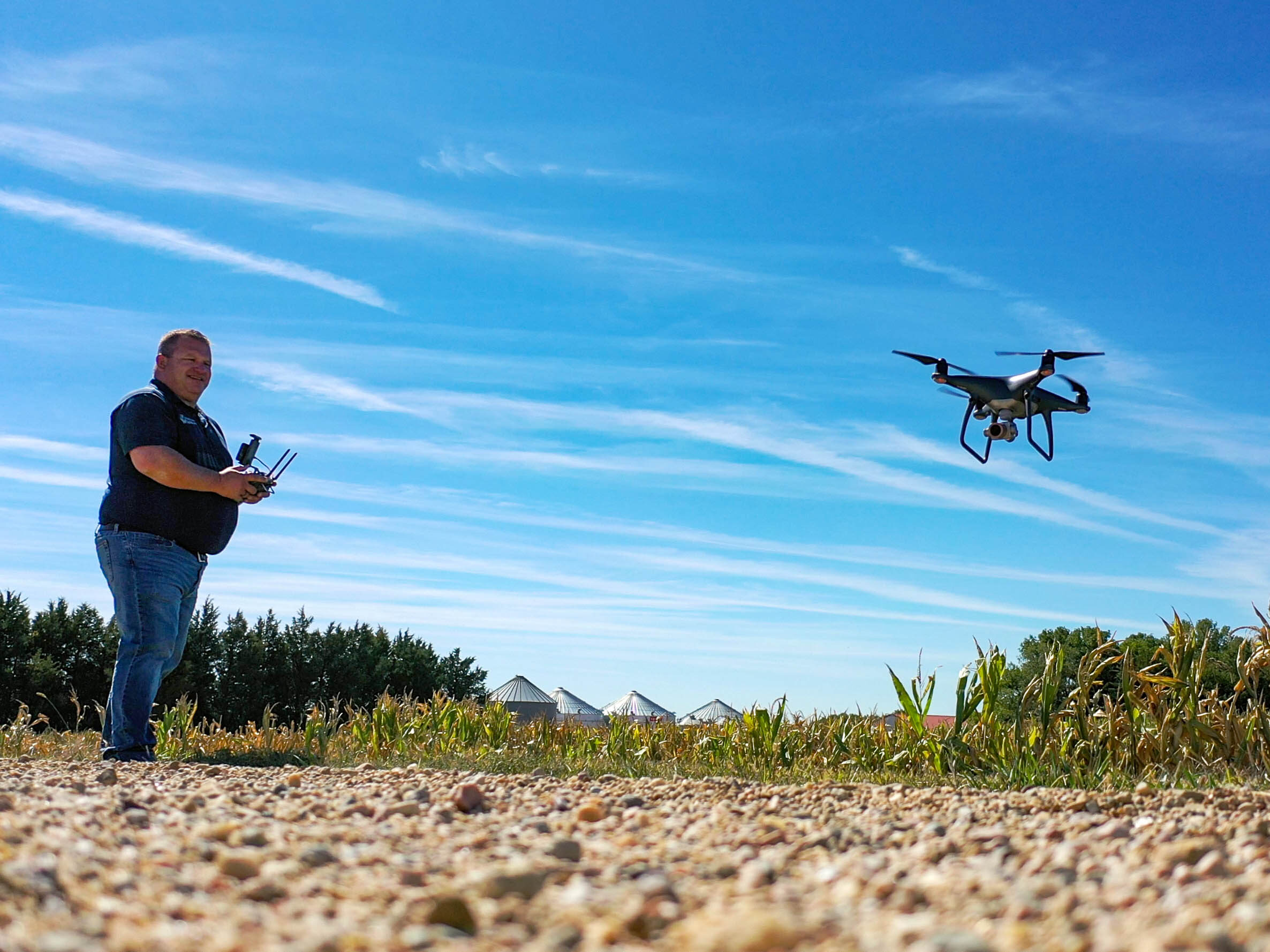 Midwest Bank Agency agent, Josh with his drone in a corn field