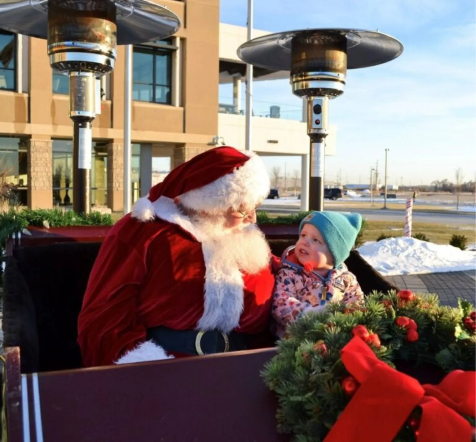 Santa with child at Christmas on Cooper Drive