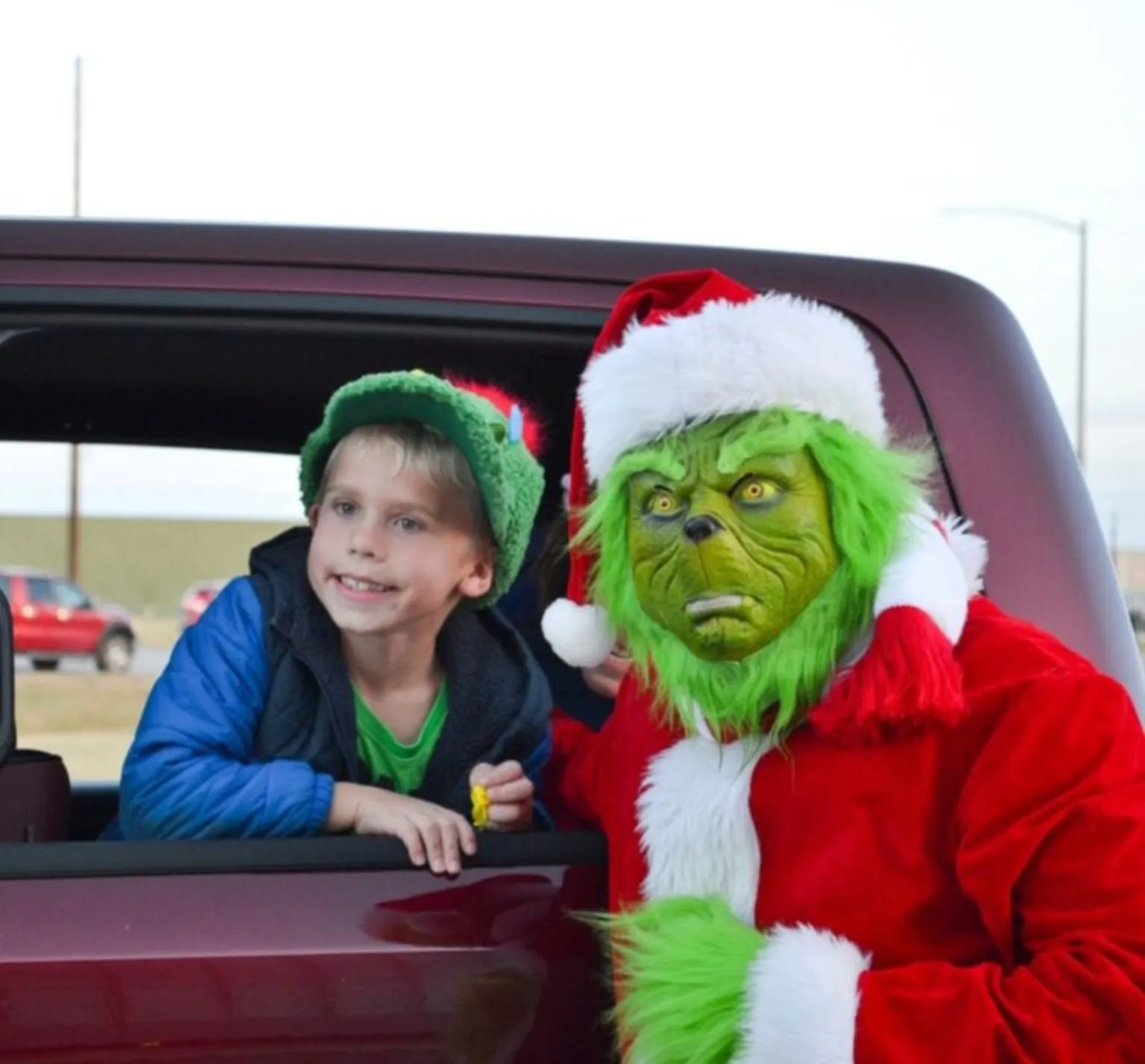 Grinch with child at Christmas on Cooper Drive