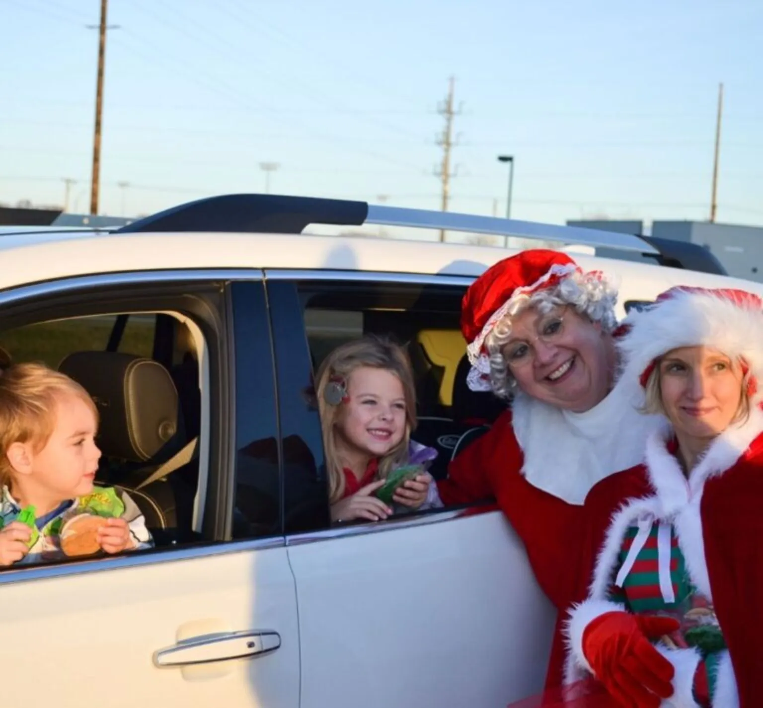 Mrs. Claus with kids at Christmas on Cooper Drive